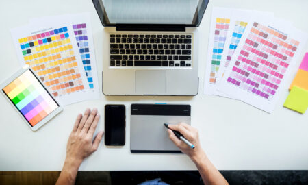 Top view of a young graphic designer working on a desktop comput design